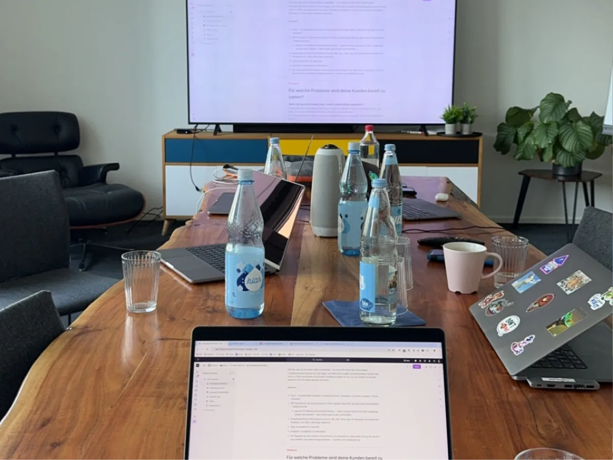 Workshop table with laptops and notes